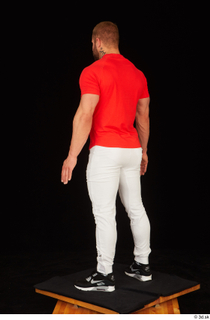 Dave black sneakers dressed red t shirt standing white pants…